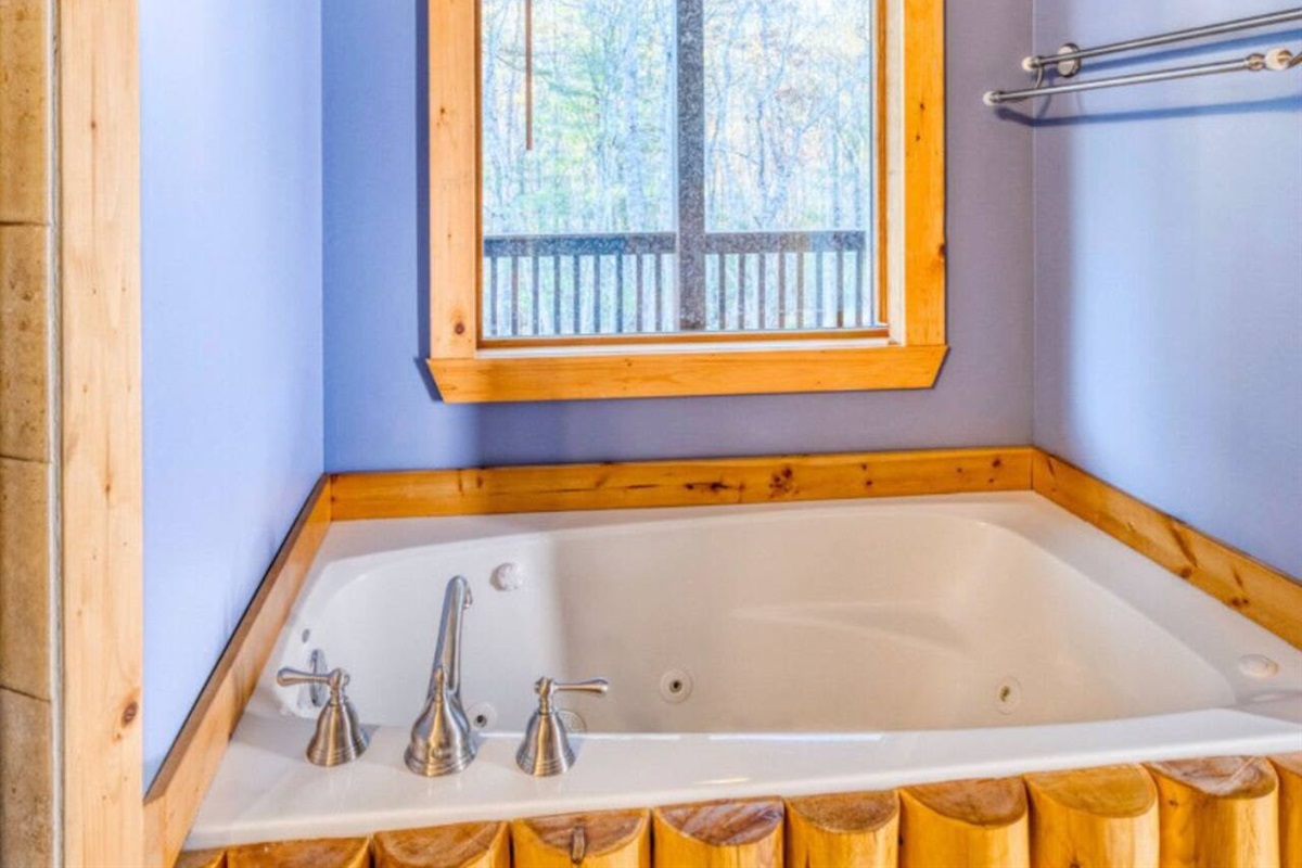 A luxurious bathtub is nestled within the master bedroom.