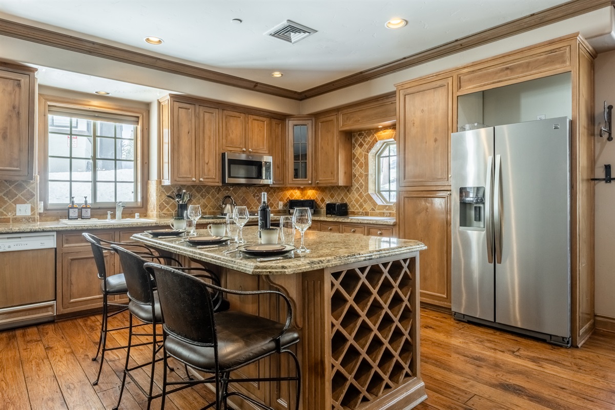 A well-appointed kitchen with granite countertops, custom cabinetry, and ample prep space—perfect for everything from quick breakfasts to shared dinners.