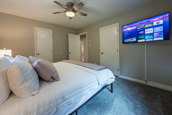 King bed, 55" Smart TV, ceiling fan, two led light nightstands with multiple charging ports, two multi light function lamps, blackout curtains, dual closets.