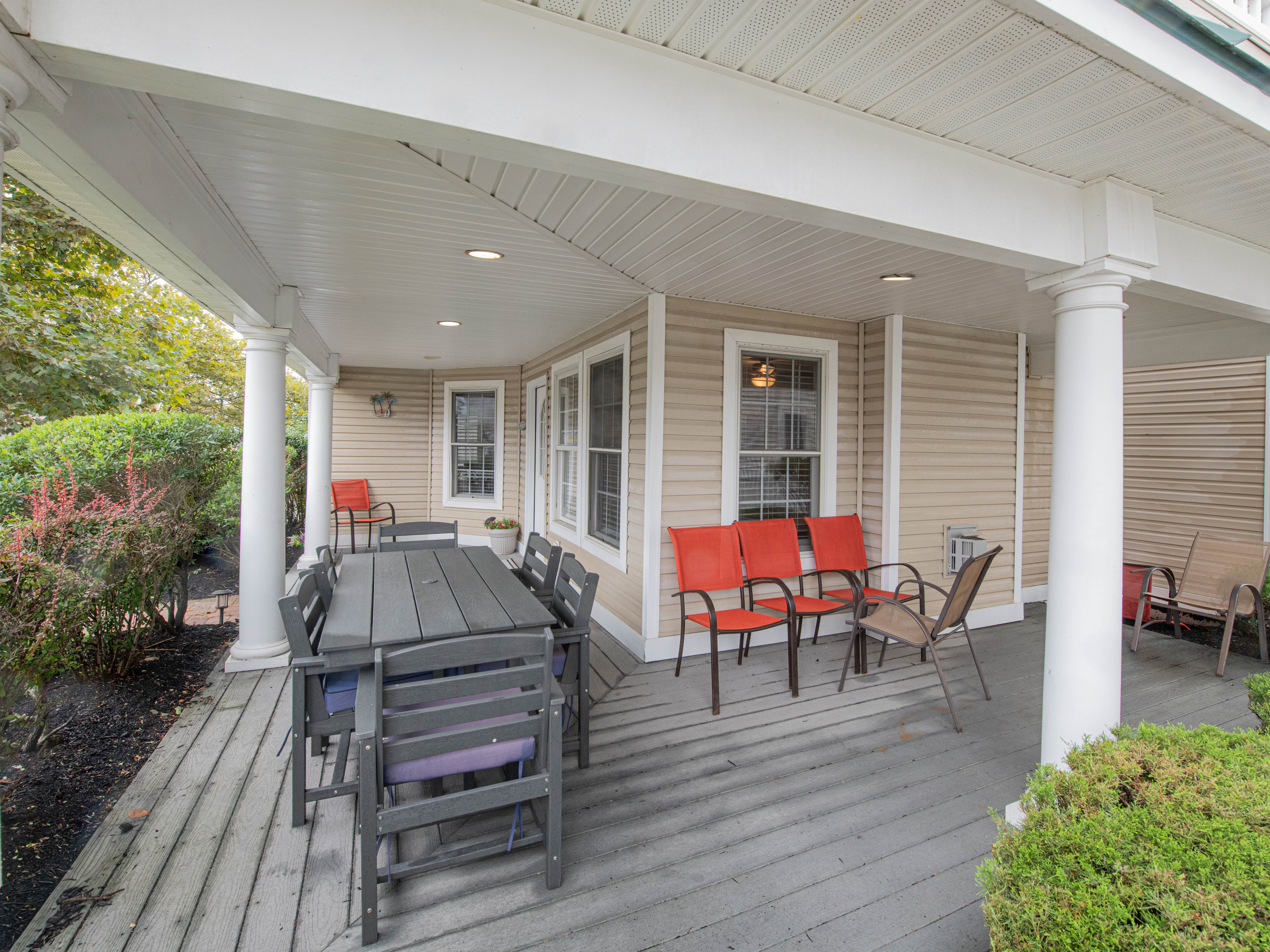 Front Porch with Outdoor Dining Table and Seating Area