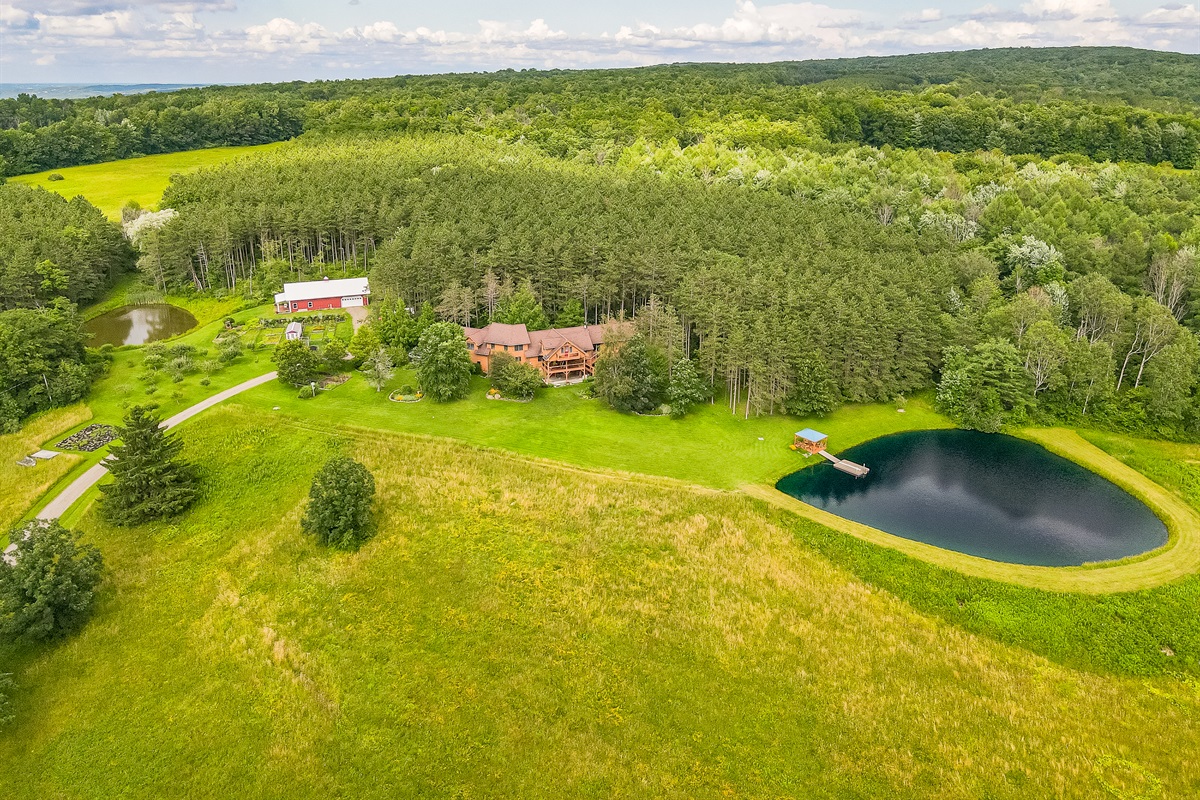 Expansive countryside estate with rolling fields, private pond, barn, and endless space to roam.