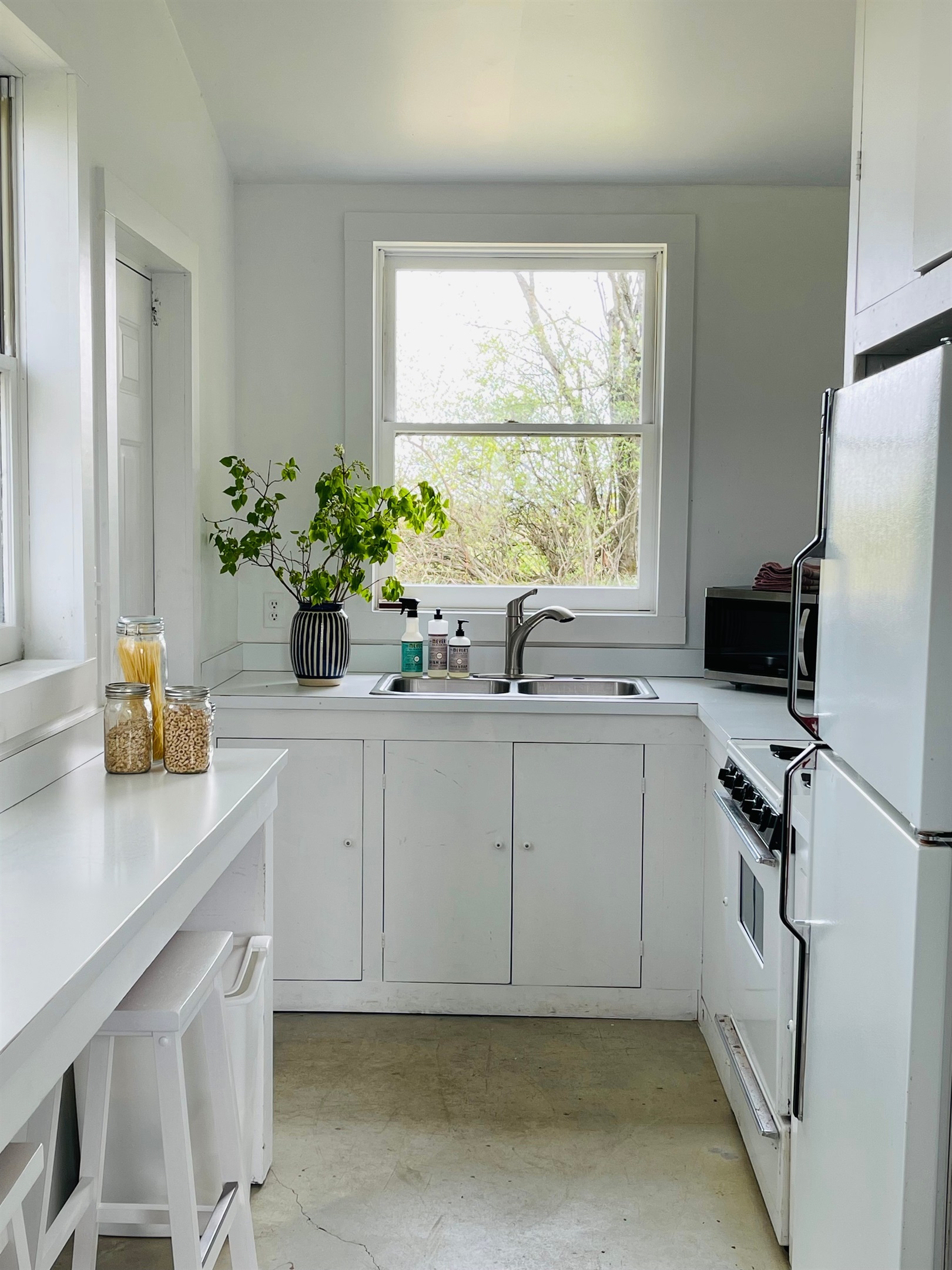 Hawk Field Pool House kitchen with bar seating looking at the view of the rolling hills.