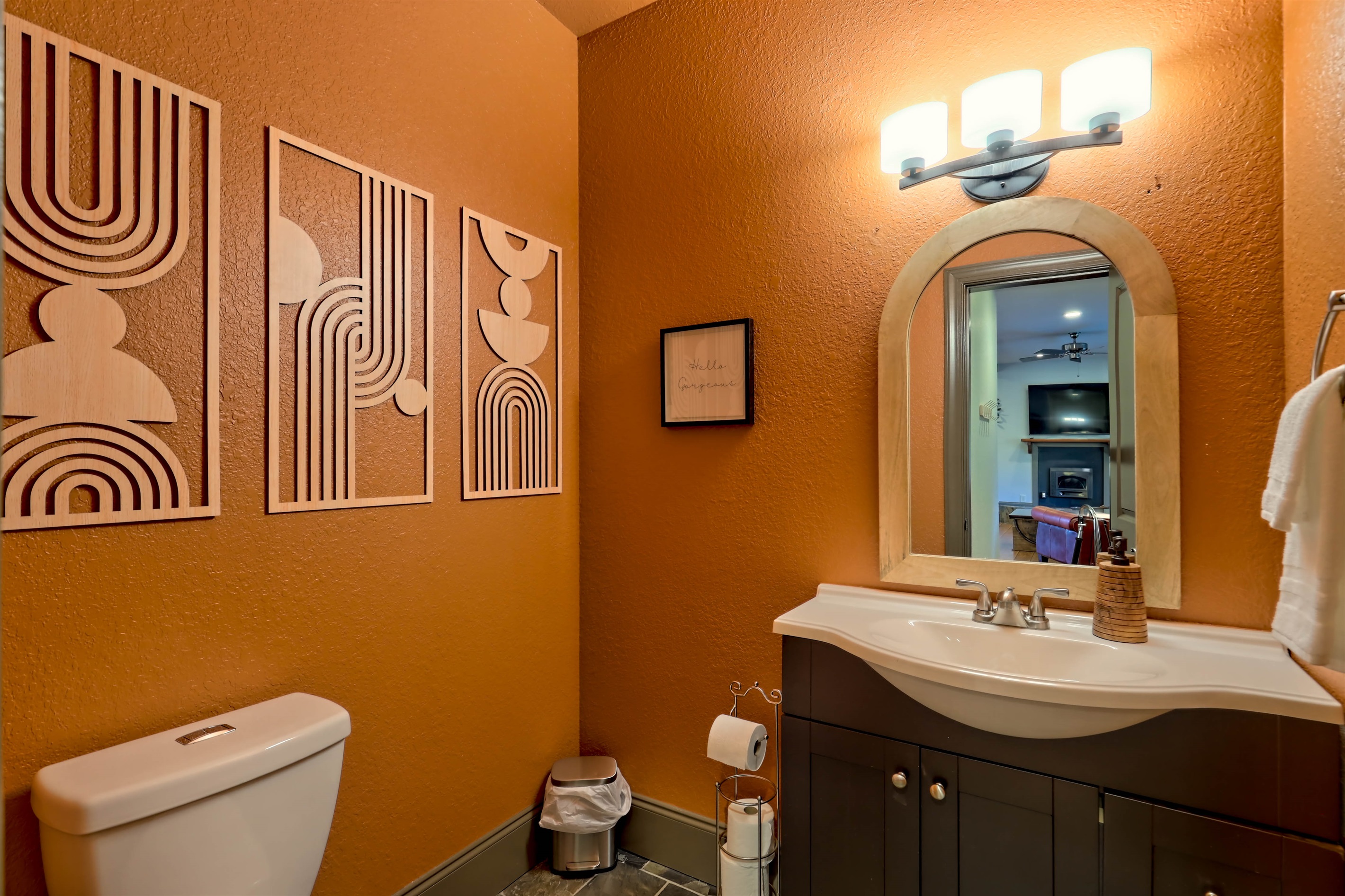 Convenient half bath with warm, modern décor.