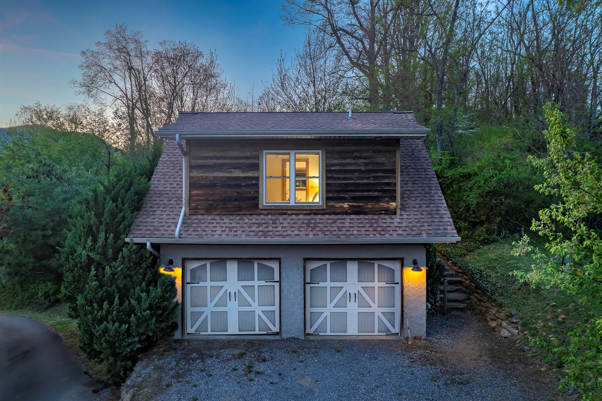 Exterior Cabin: Charming mountain retreat with rustic wood accents and inviting evening glow!