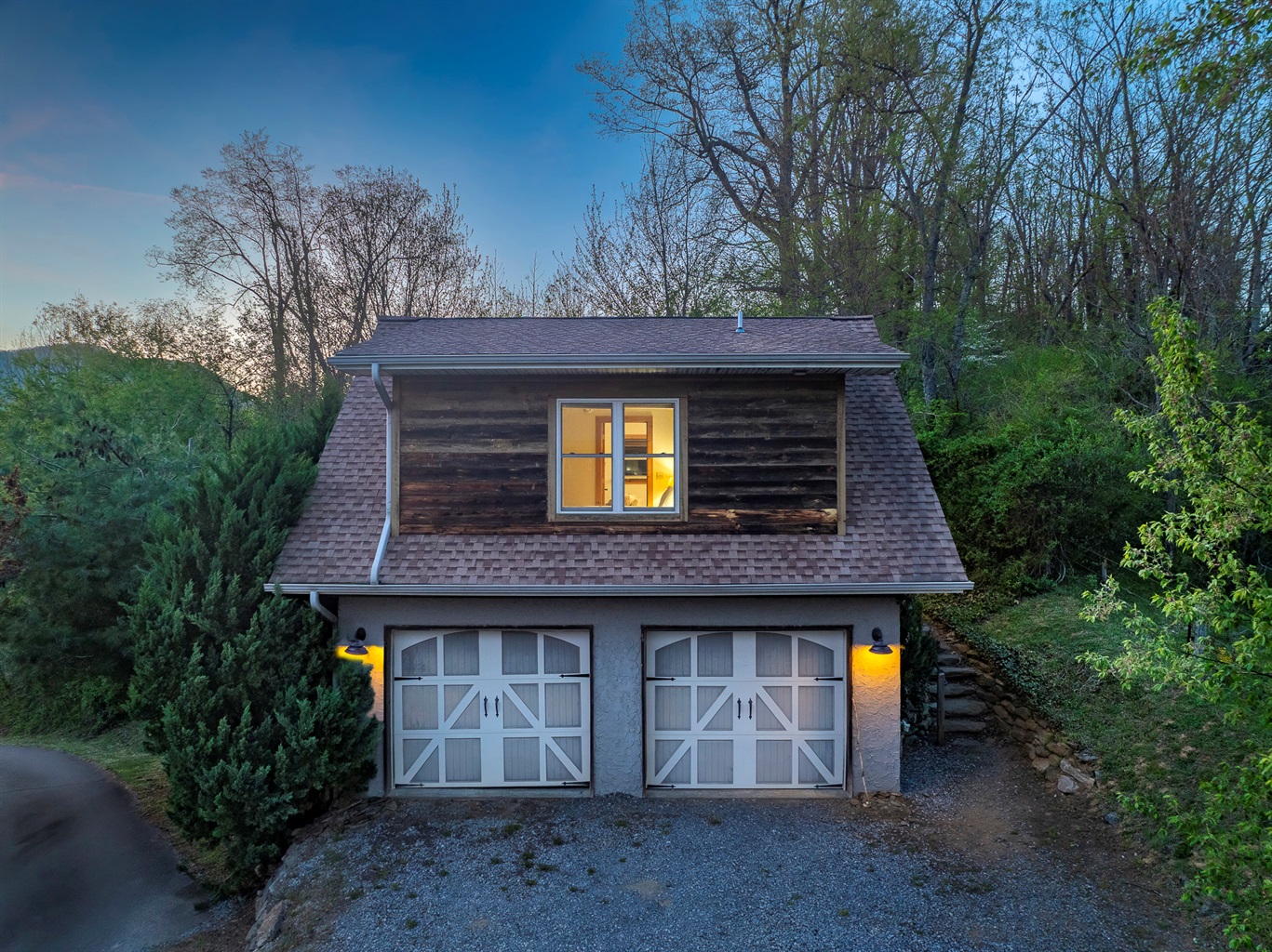 Exterior Cabin: Charming mountain retreat with rustic wood accents and inviting evening glow!