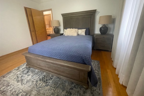 Queen master bedroom with nightstands, dresser, and 42" TV.