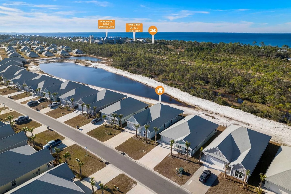 Aerial view of a peaceful coastal community surrounded by nature and water views.