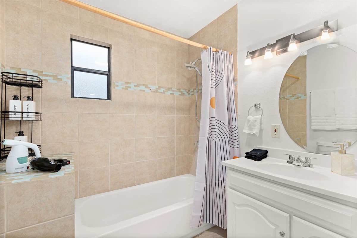 Indulge in a soothing bath or a quick shower in our clean and bright bathroom, complete with fresh towels. essential amenities, and bidet.