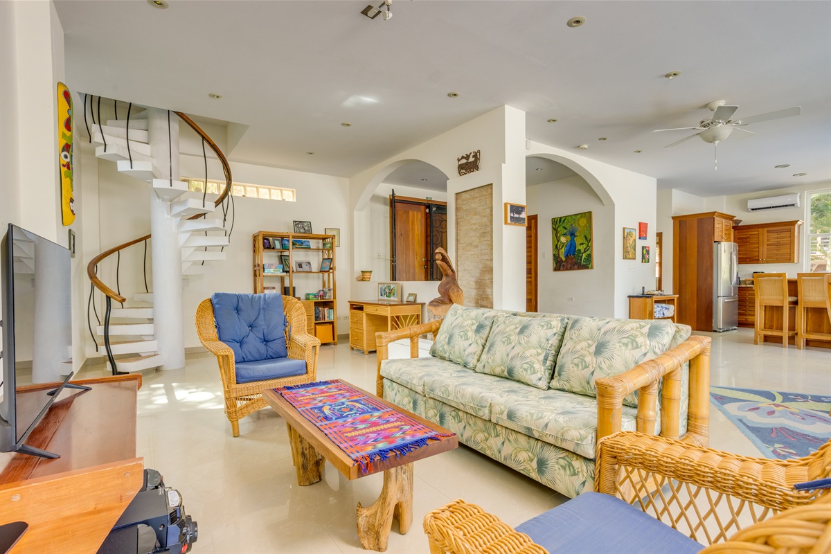 Living room with sofa and arm chairs, open concept