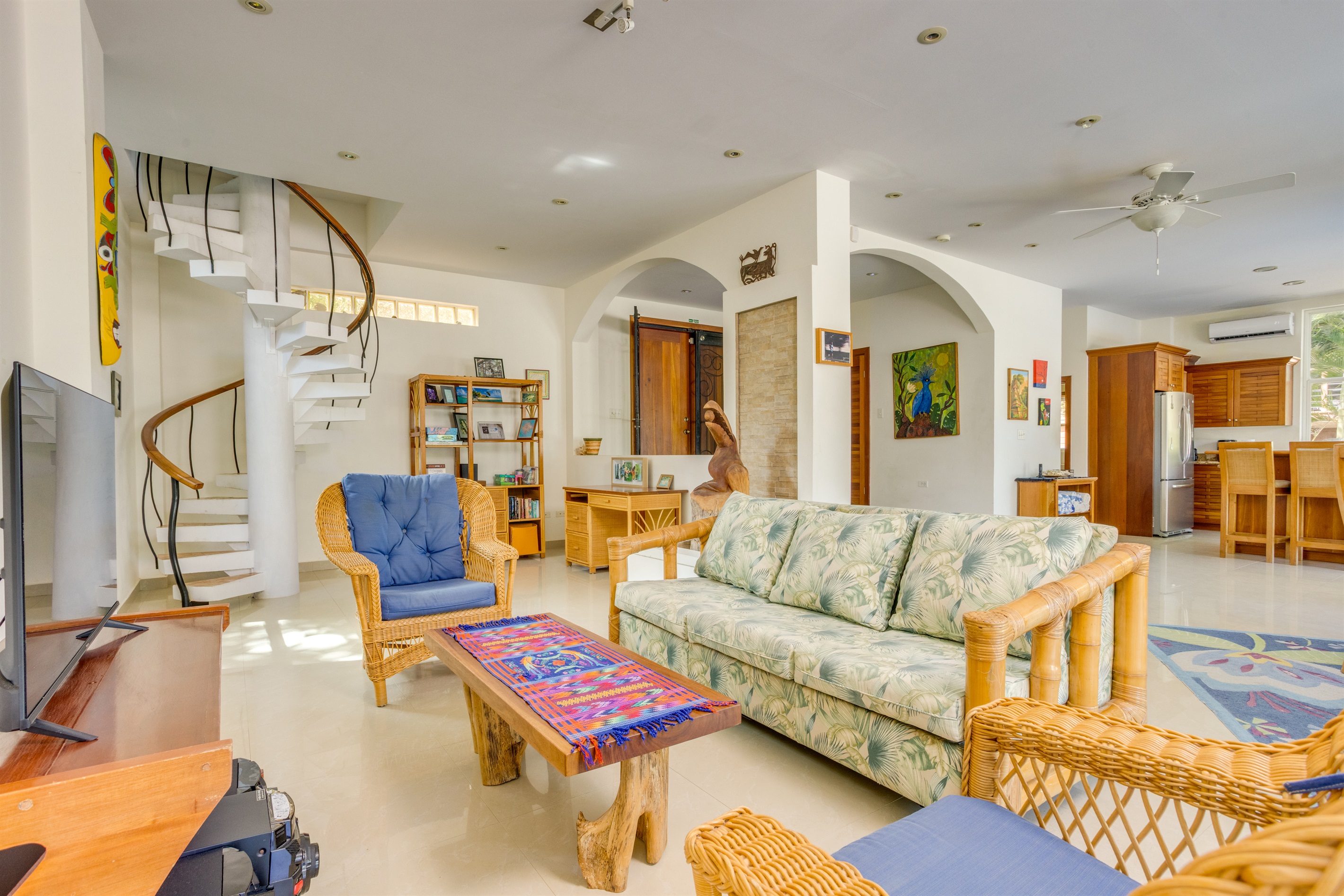 Living room with sofa and arm chairs, open concept