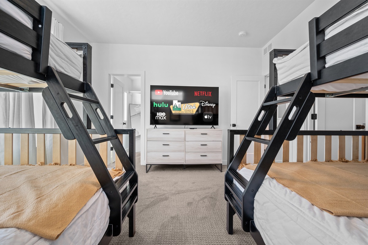 Spacious bunk room with two full-over-queen bunk beds, perfect for kids or groups.
