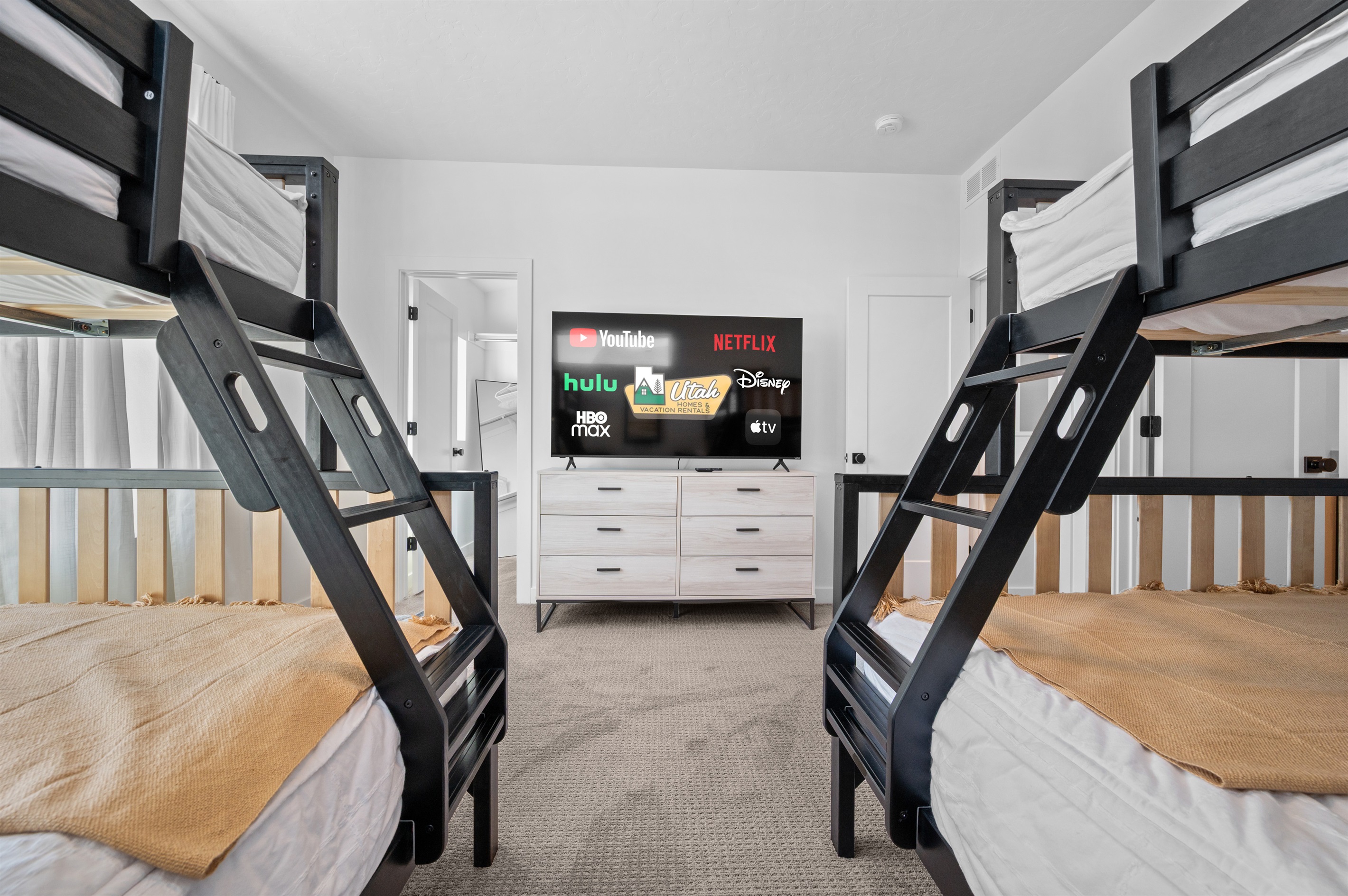 Spacious bunk room with two full-over-queen bunk beds, perfect for kids or groups.