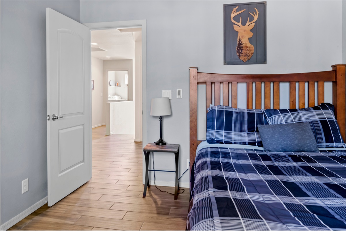 Cozy up in the second bedroom, featuring a comfortable queen bed, perfect for a good night's sleep after a day of exploring.