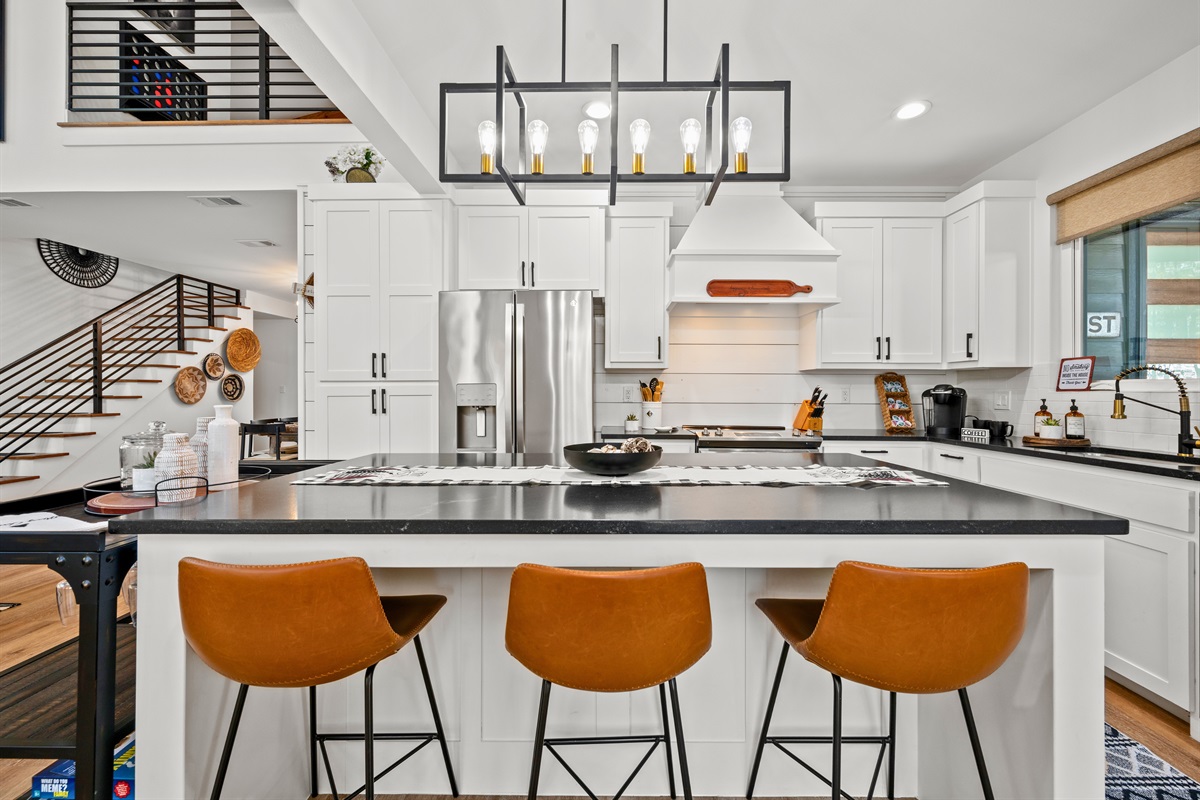 Seating along the island creates an easy spot for morning coffee, casual meals, or keeping the cook company.