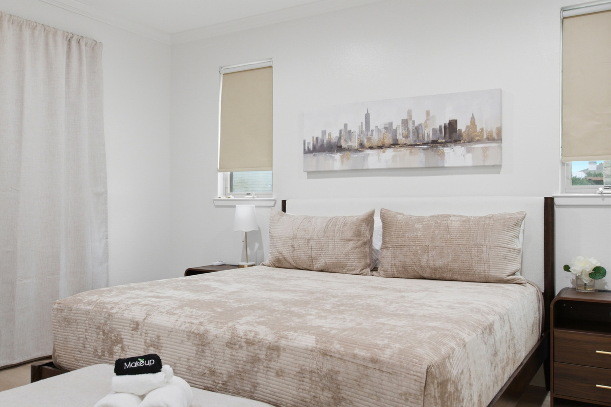 Chic bedding and city views invite relaxation after a fun day in Dallas!
