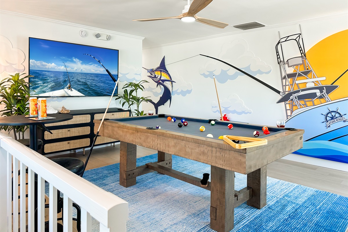 Featuring two game rooms, one including a pool table and infinity game table.