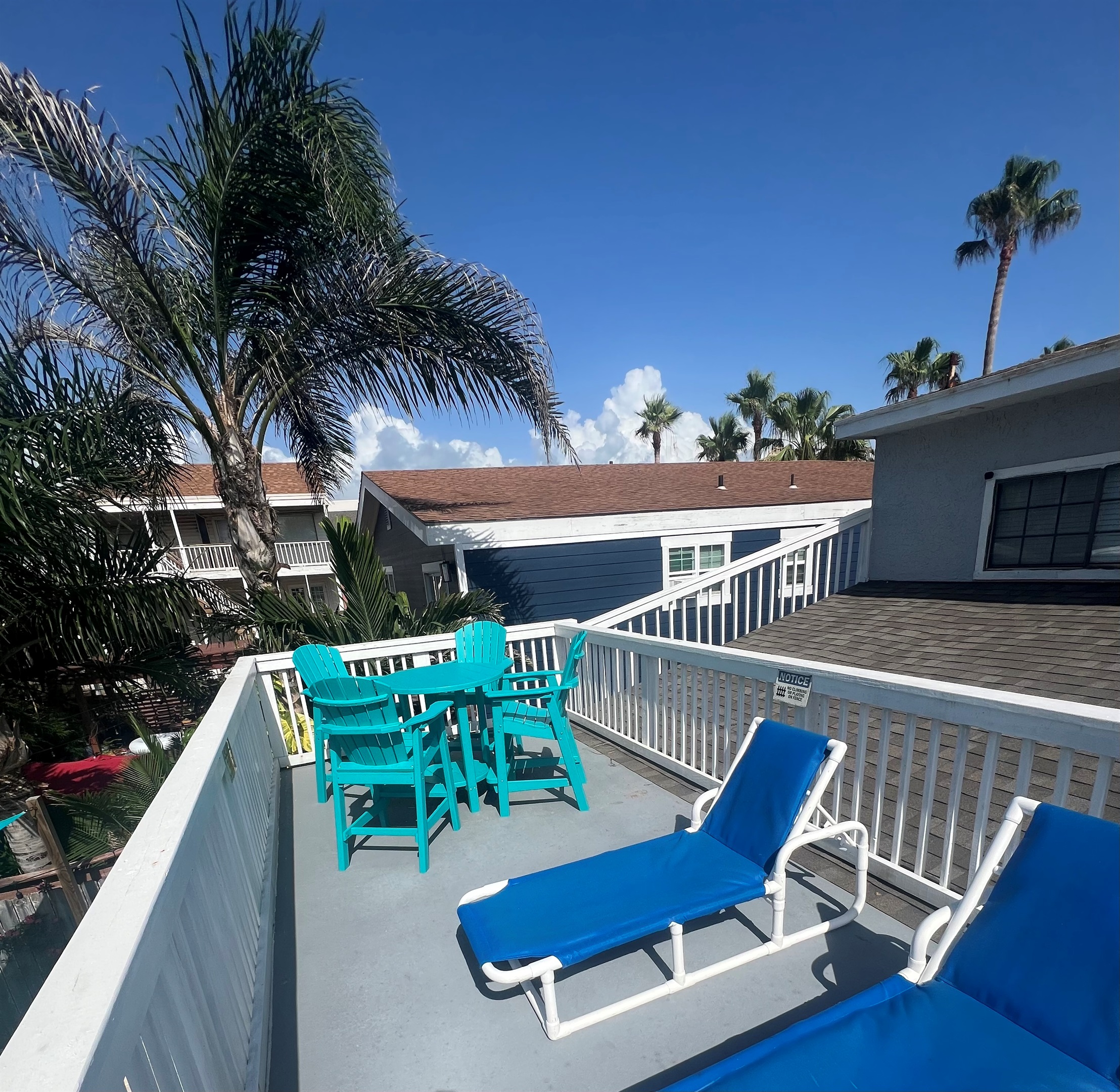 Bar height table and chairs on upper deck with lounge chairs for relaxing or soaking up a little sun. 
