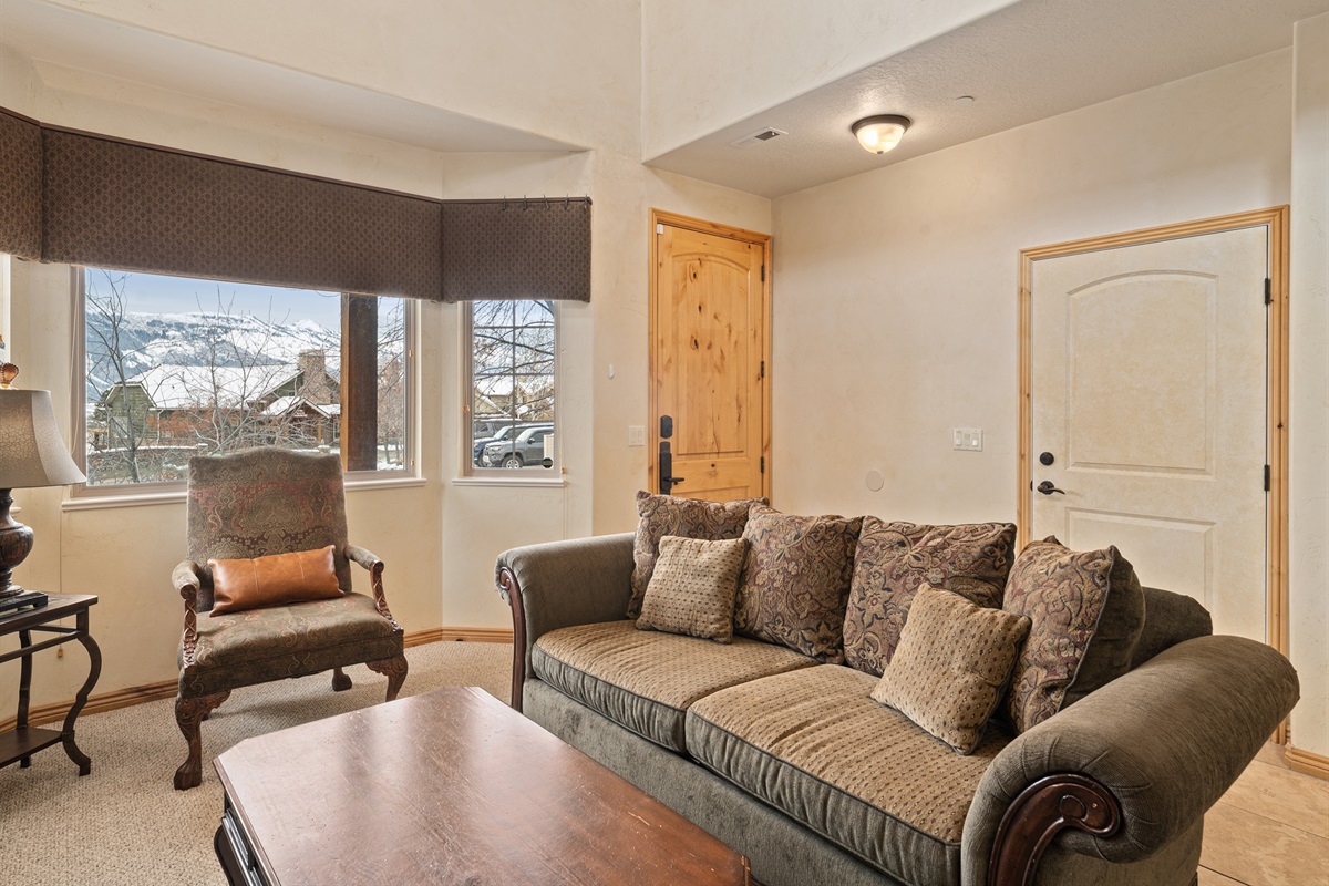 Bright living area with large windows and comfortable seating