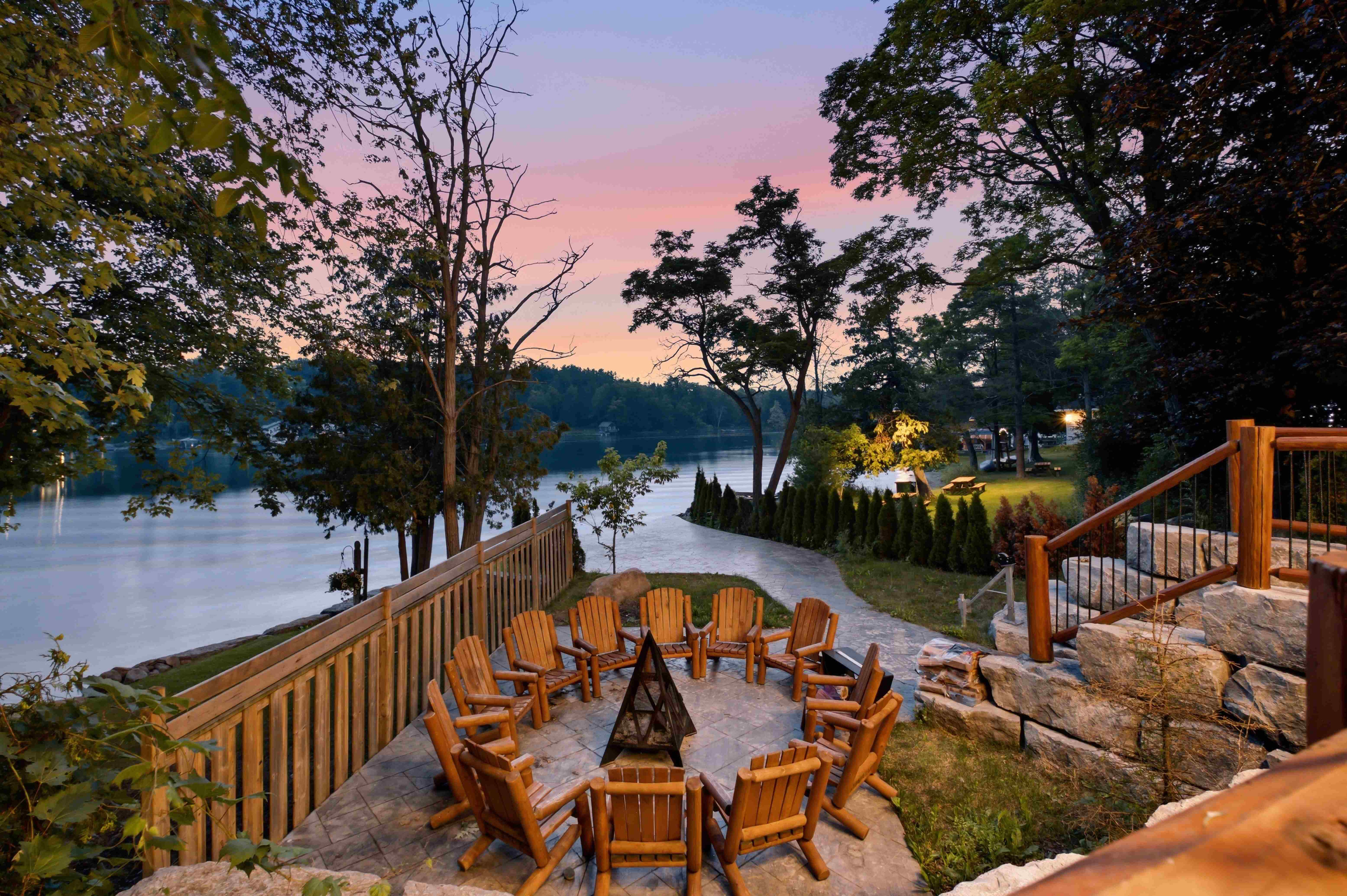Waterfront firepit and Adirondack seating at sunset