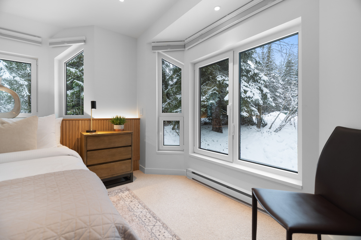 Bedroom 2 windows with snowy forest views