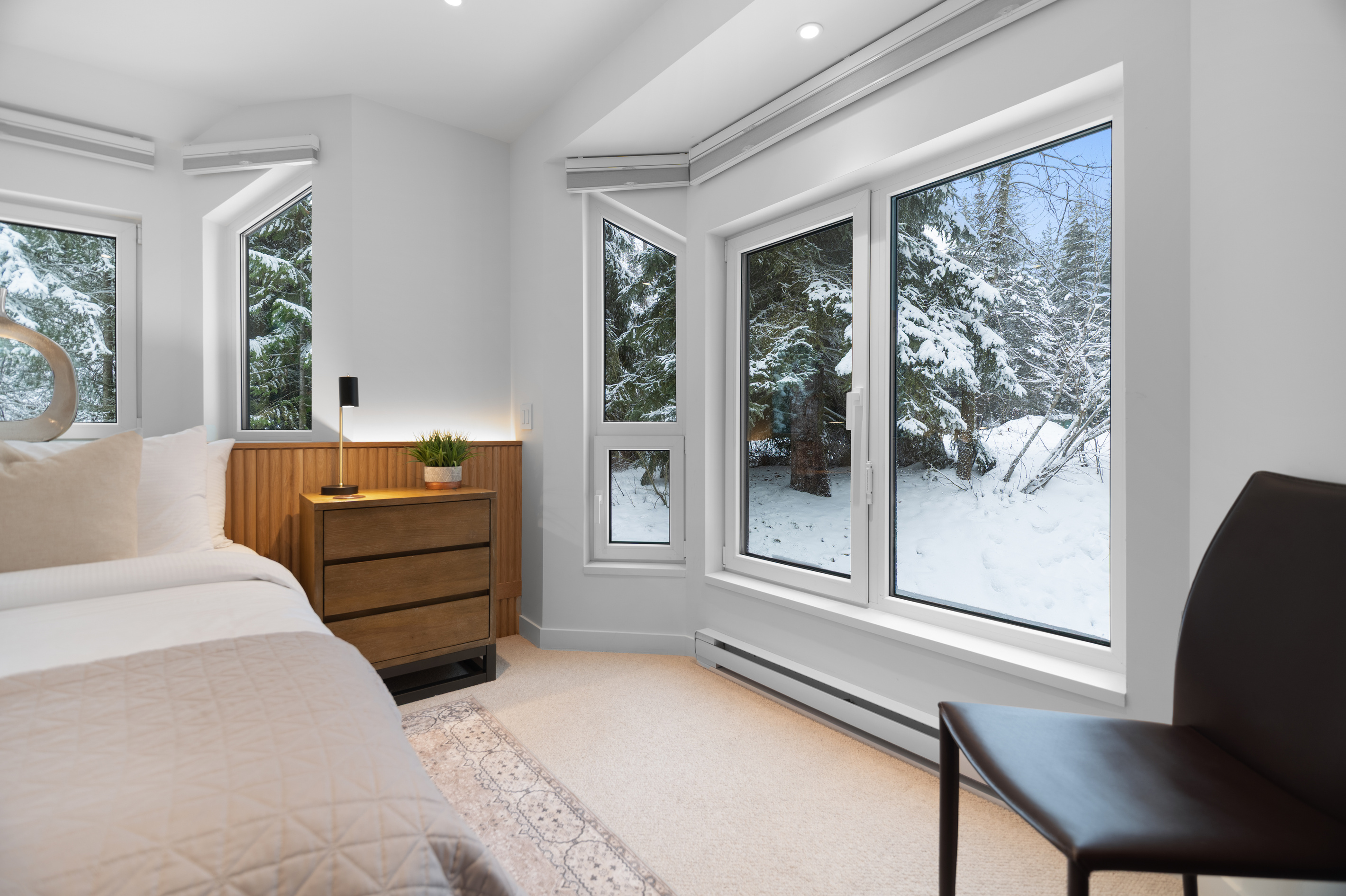 Bedroom 2 windows with snowy forest views