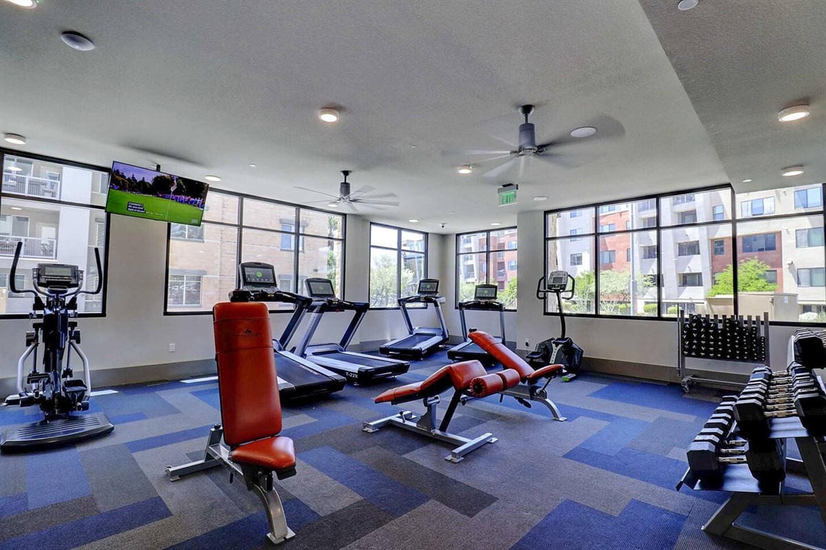 - Keep your fitness goals strong in a fully equipped gym with cardio machines   - Enjoy natural light, modern floors, and a motivating workout environment   - Includes treadmills, free weights, and benches for every fitness routine