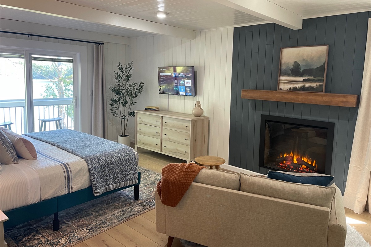 Bedroom 1 - King bed, ensuite bathroom, lake view and balcony, sitting area with electric fireplace