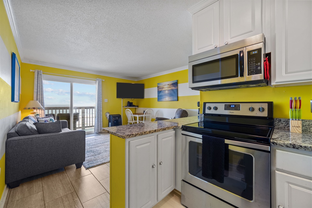 Open kitchen layout that connects to the living area and balcony with ocean views