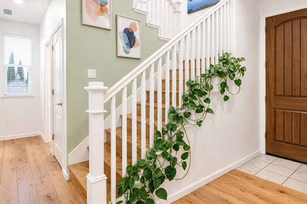 Welcoming entry with staircase and decor