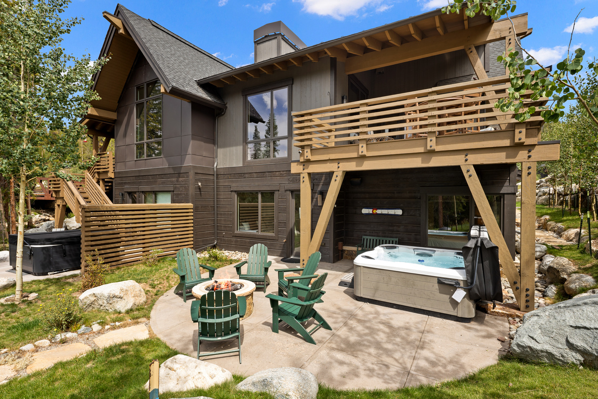 Riverside outdoor living space with private hot tub and gas fire pit
