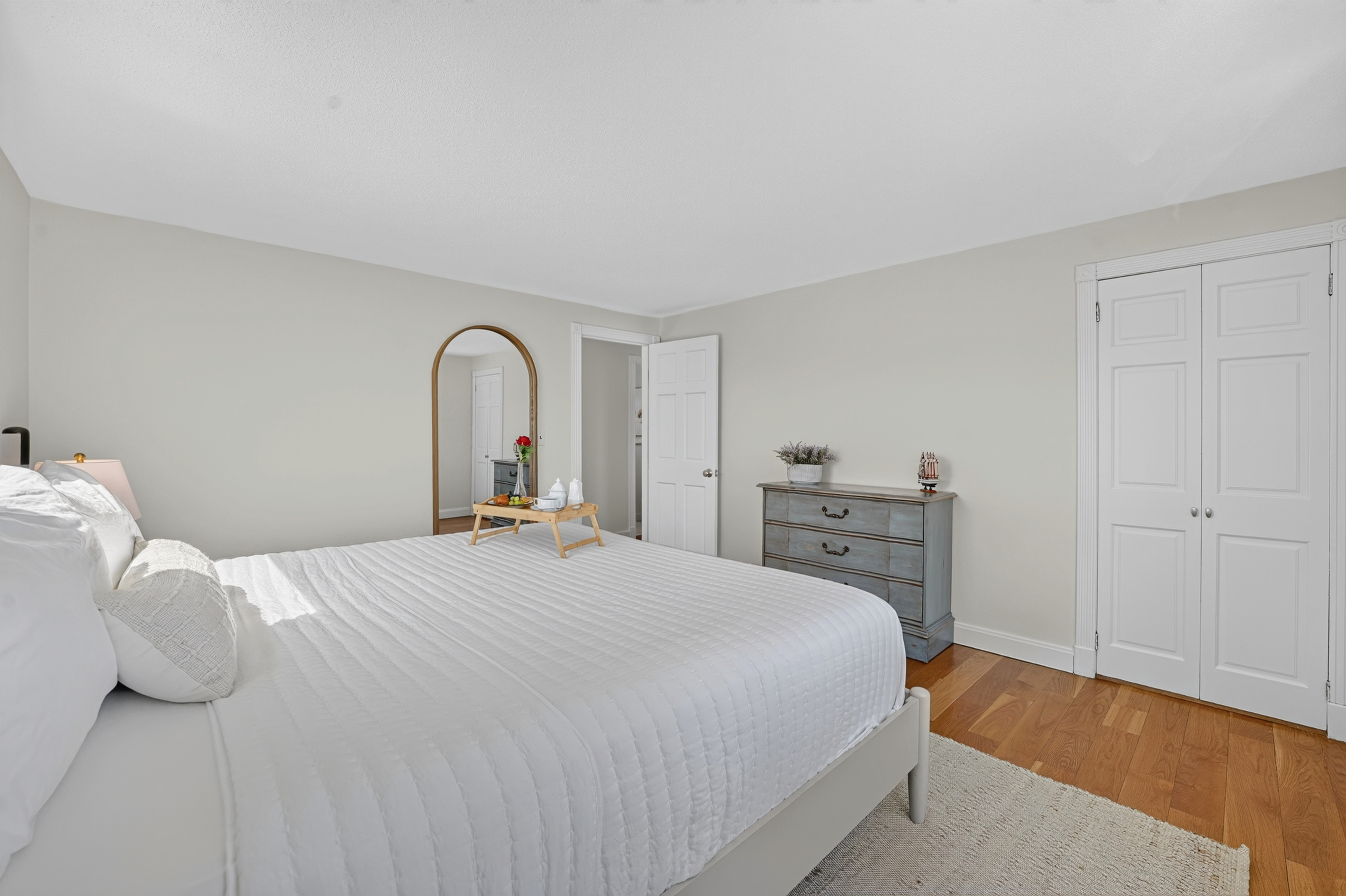 Comfortable bedroom with a clean, calming atmosphere and convenient storage space.