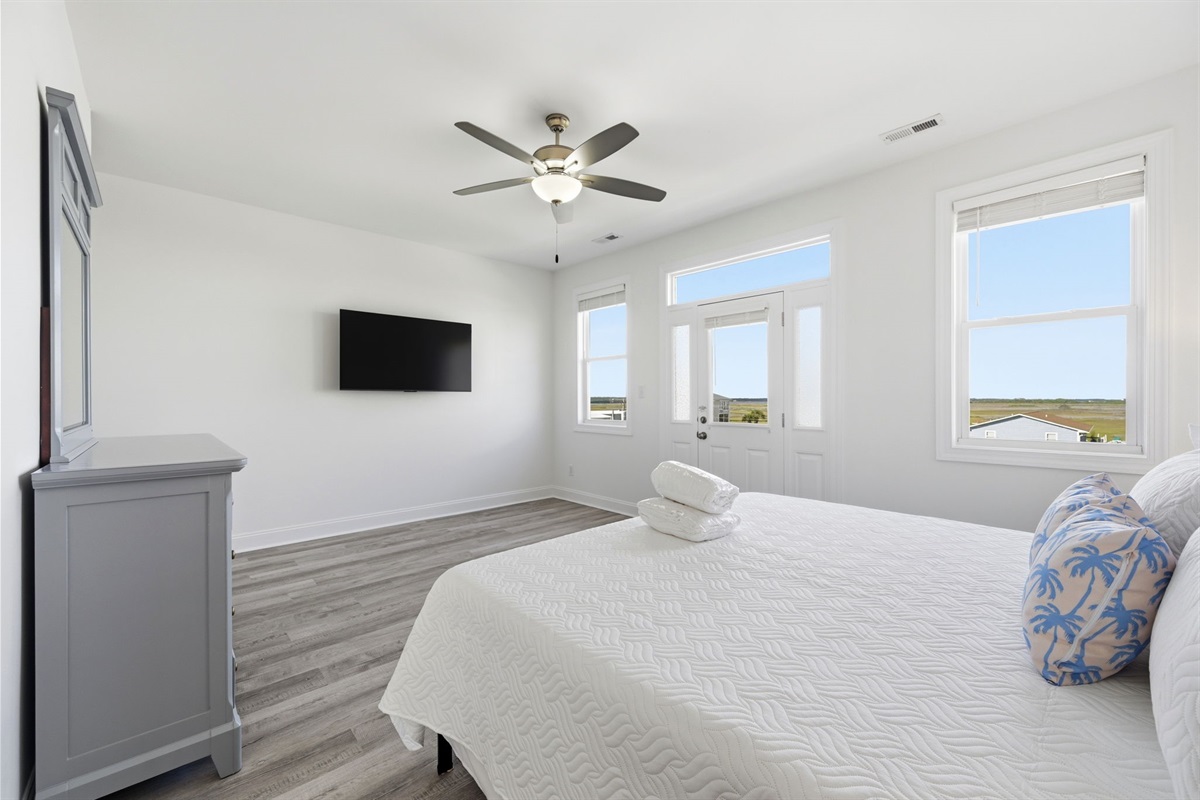 Spacious second-floor master suite with king bed and private sound-side balcony access