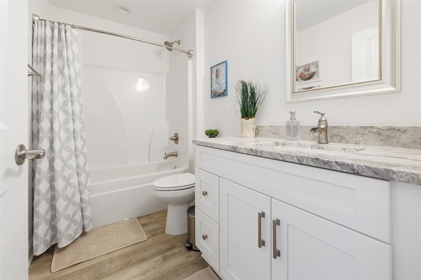 The second bathroom is located near the other three bedrooms, opposite side of the master bedroom.