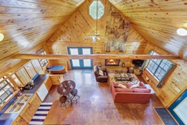 View of living room and kitchen space from upstairs loft.