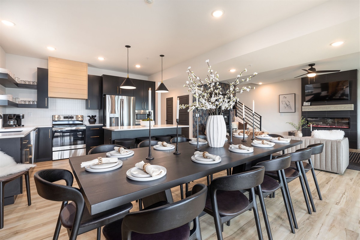 Seating for 12 at the dining table along with extra seating at the island and bar along the wall