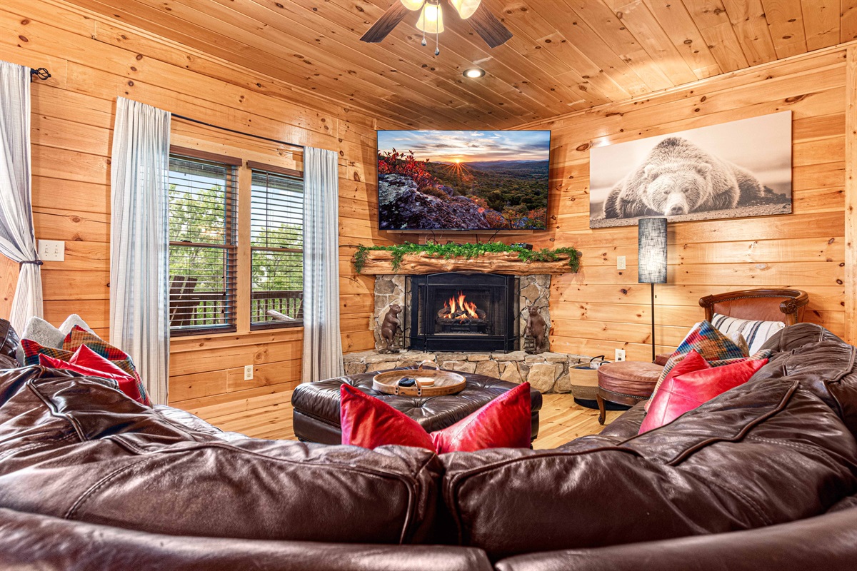 Living Room Retreat: Gather around the fireplace with stunning views and plush leather seating!