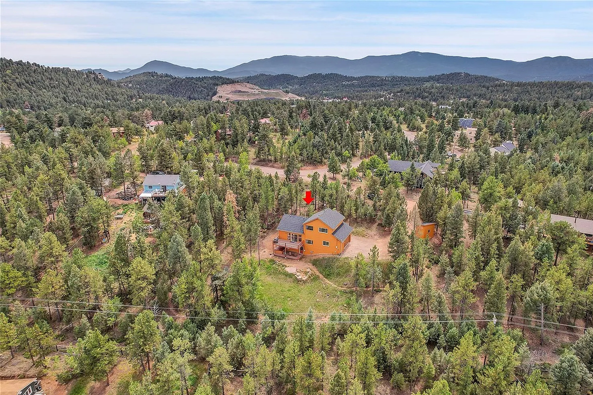 Expansive aerial perspective showing the cabin's secluded setting.