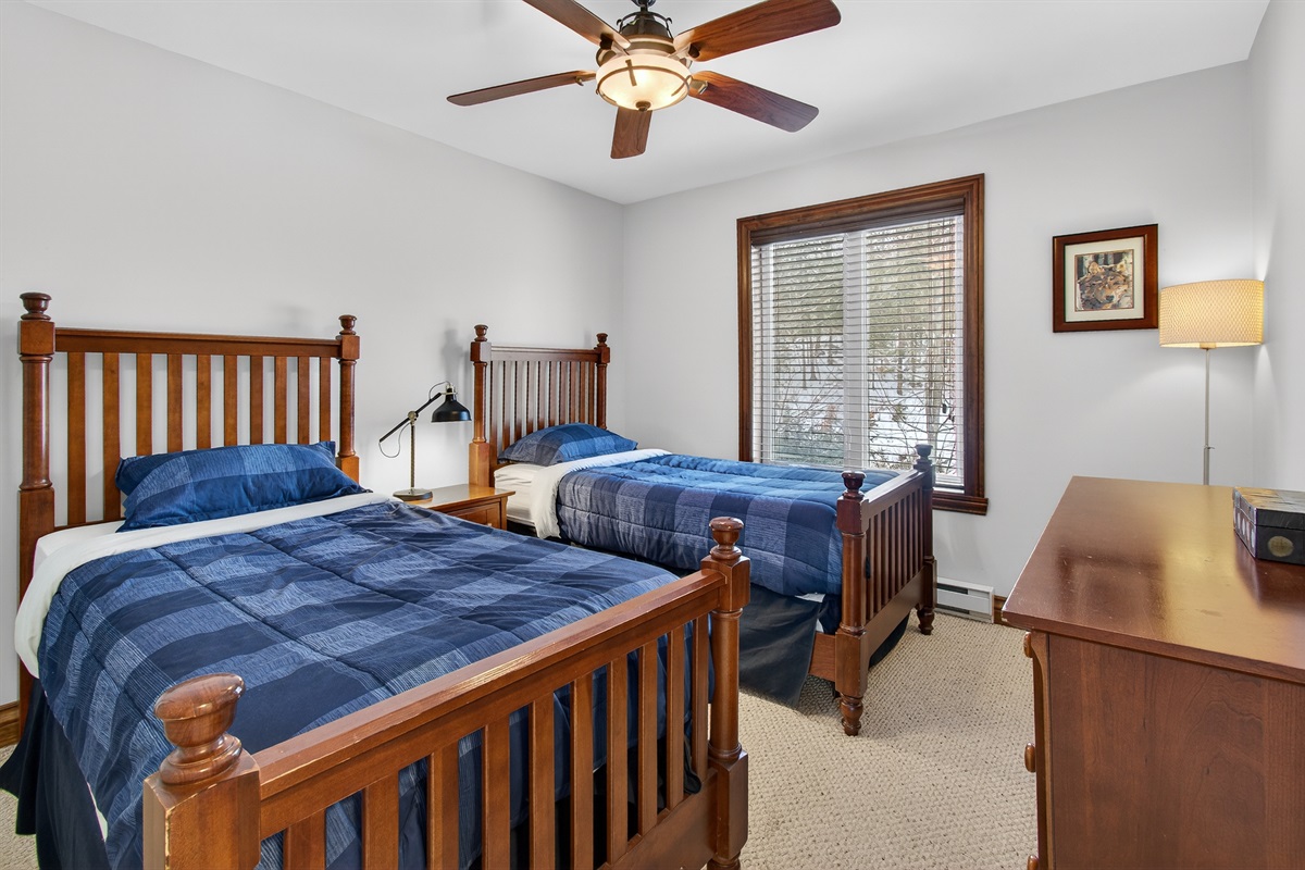 Upstairs twin bedroom w/ two beds & a cozy setup.