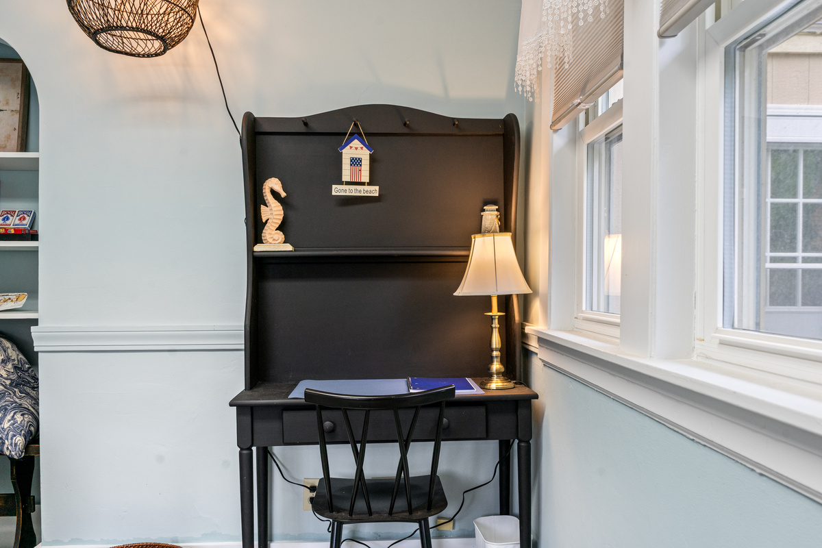 Catch up on remote work or write a postcard from the quiet den hutch desk. Positioned next to the window with a warm brass lamp, cozy seating, and a dedicated workspace, this peaceful corner lets you stay productive without any family distractions.