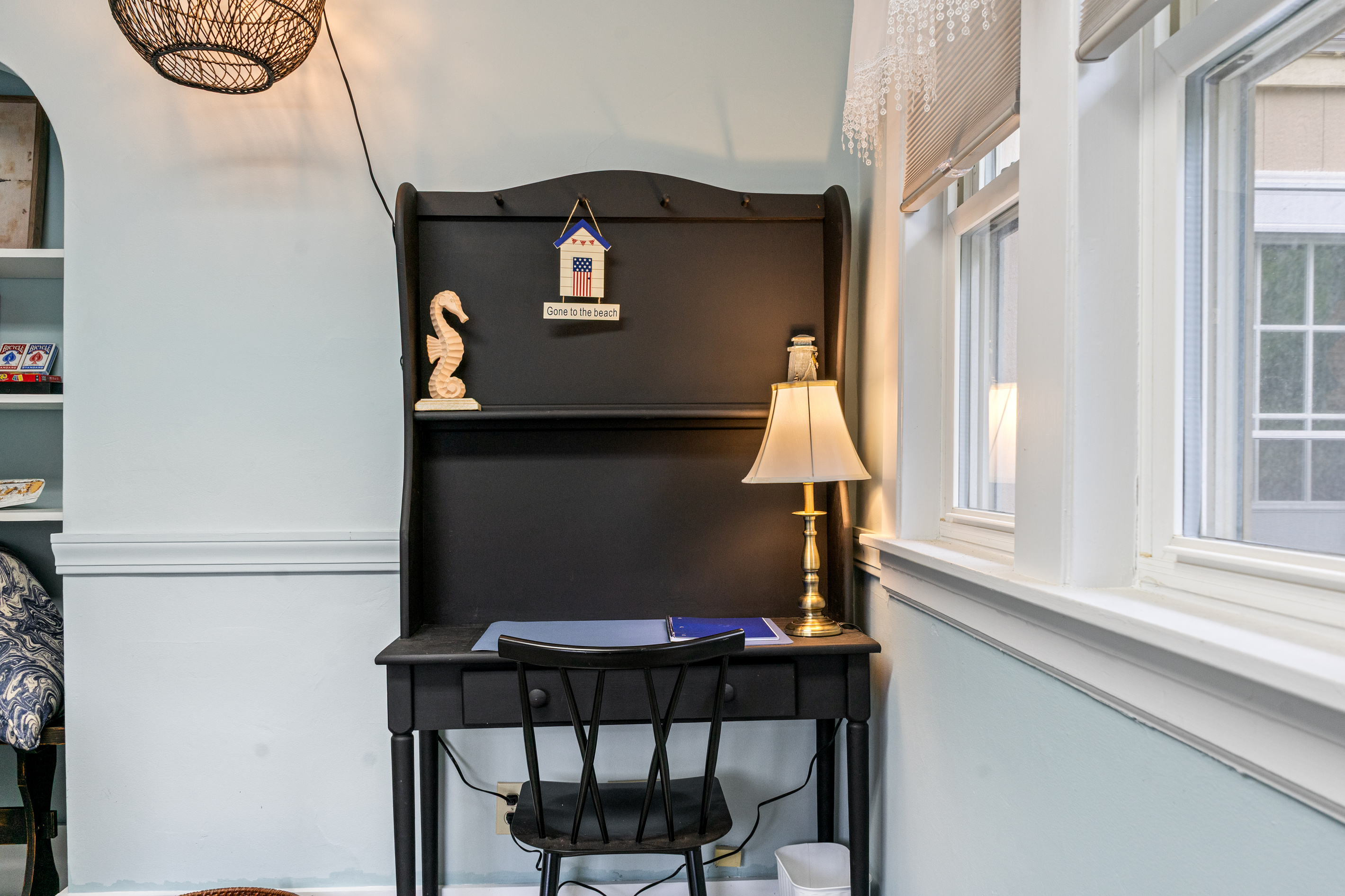Catch up on remote work or write a postcard from the quiet den hutch desk. Positioned next to the window with a warm brass lamp, cozy seating, and a dedicated workspace, this peaceful corner lets you stay productive without any family distractions.