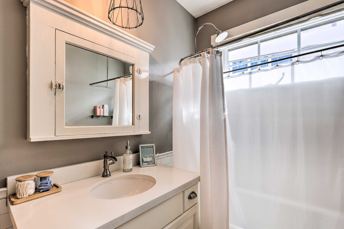 A charming vintage vanity and clawfoot-style tub bring timeless character to your morning routine.