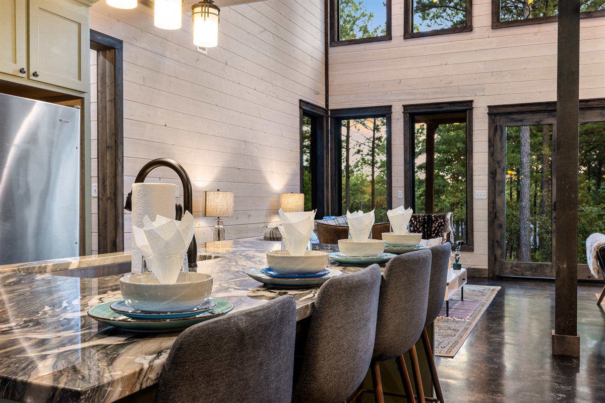 Spacious kitchen island with seating for four, perfect for casual meals, morning coffee, or gathering while cooking together.
