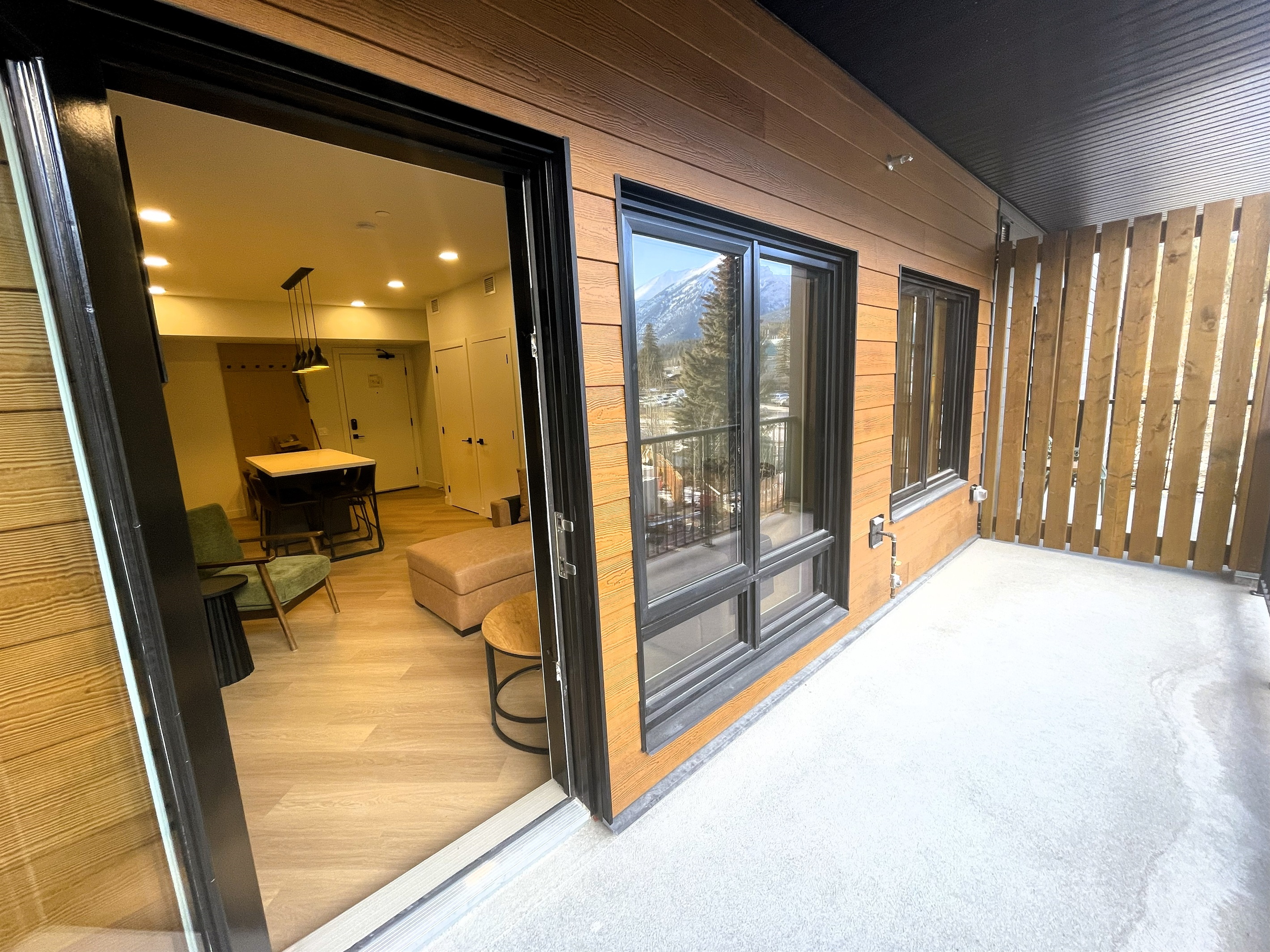 Spacious private balcony with mountain view in each direction. Living room area visible through the patio door.  