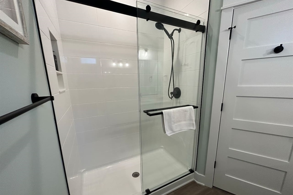 Large shower in the master bathroom is tiled and includes a massage shower head.  