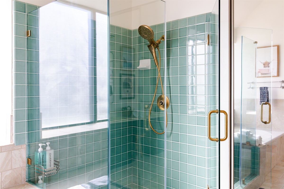 Our primary bedroom boasting a modern standing shower with sleek glass enclosure.