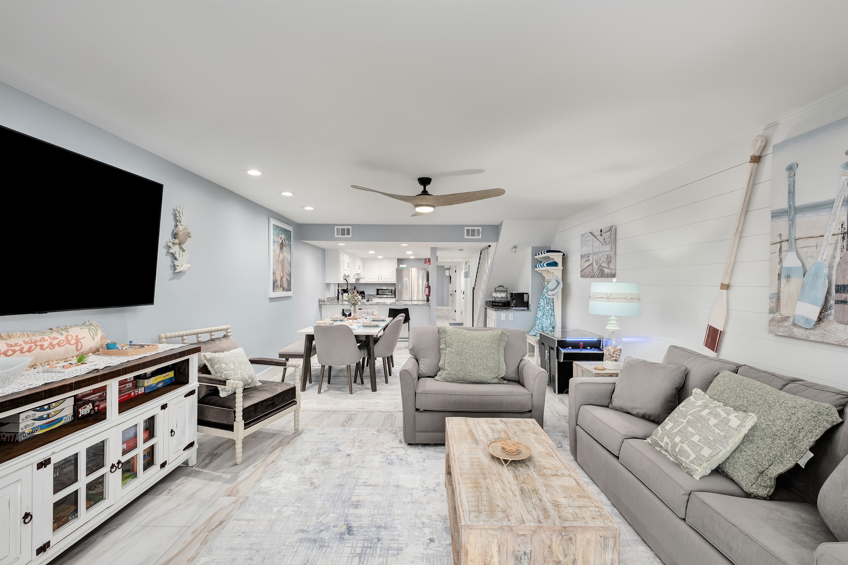 Relax in the spacious living room featuring modern amenities and a large flat-screen TV, plenty of board games and an arcade Ideal for family entertainment.