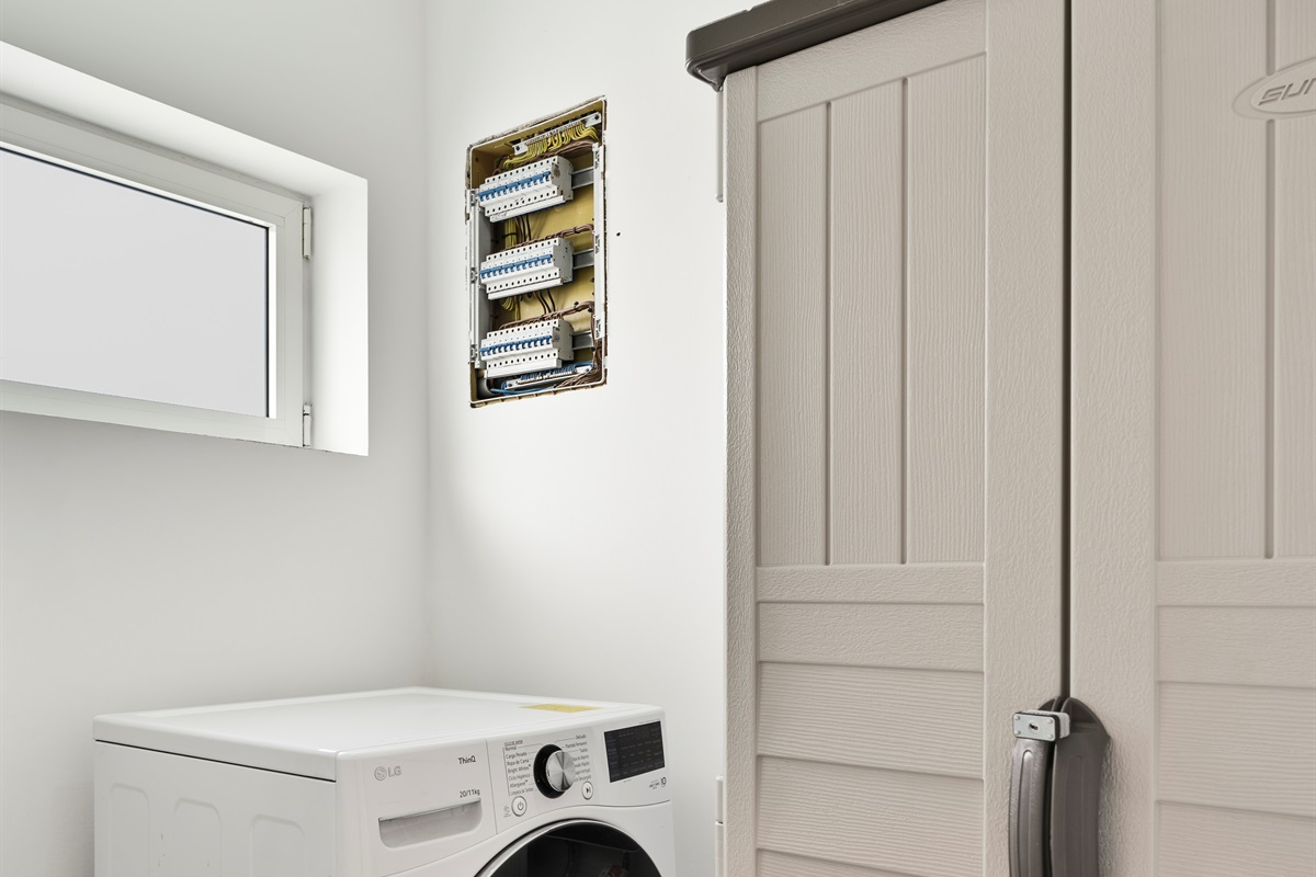 An all in one washer-dryer in the laundry room to handle washing and drying in one cycle