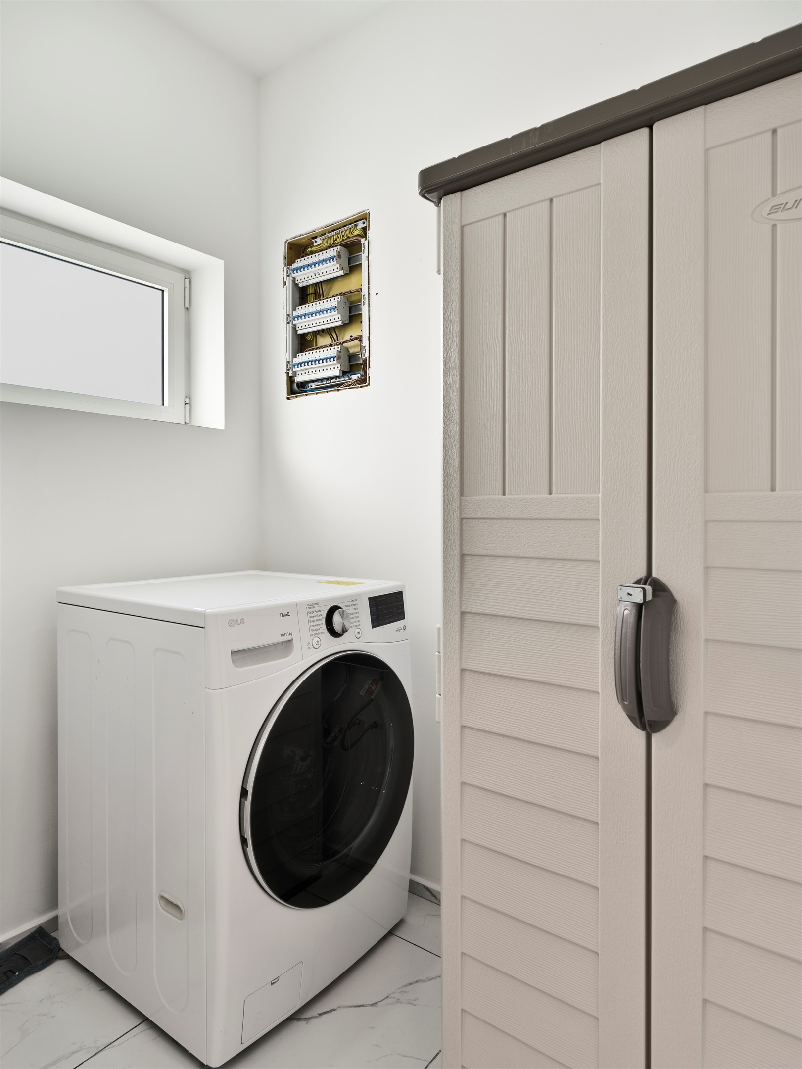 An all in one washer-dryer in the laundry room to handle washing and drying in one cycle