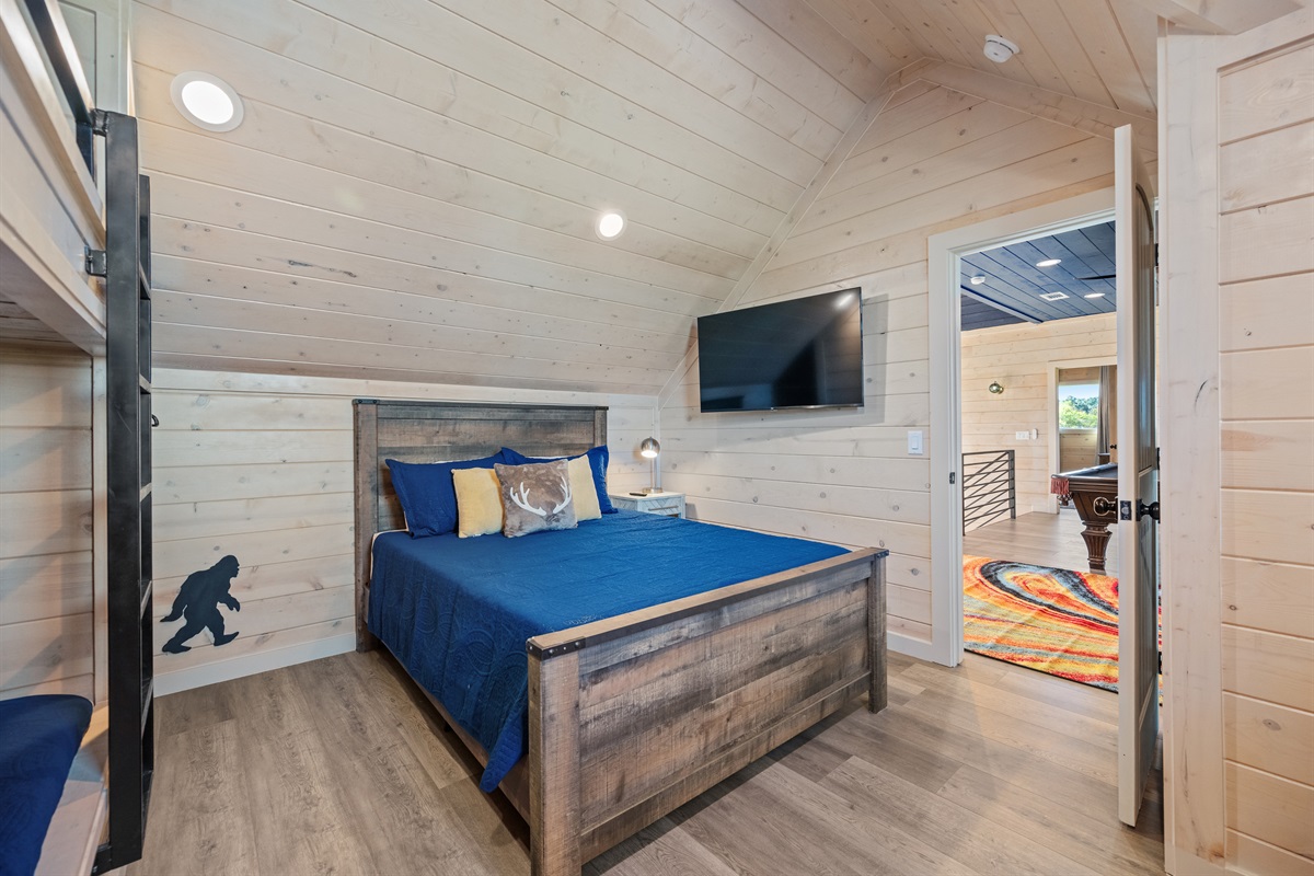 Bedroom 4 with queen bed and TV, cozy space for guests.