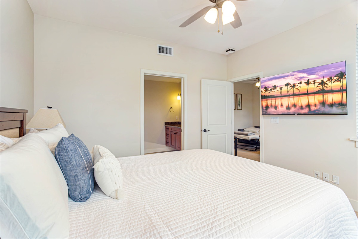Primary bedroom with queen bed and TV